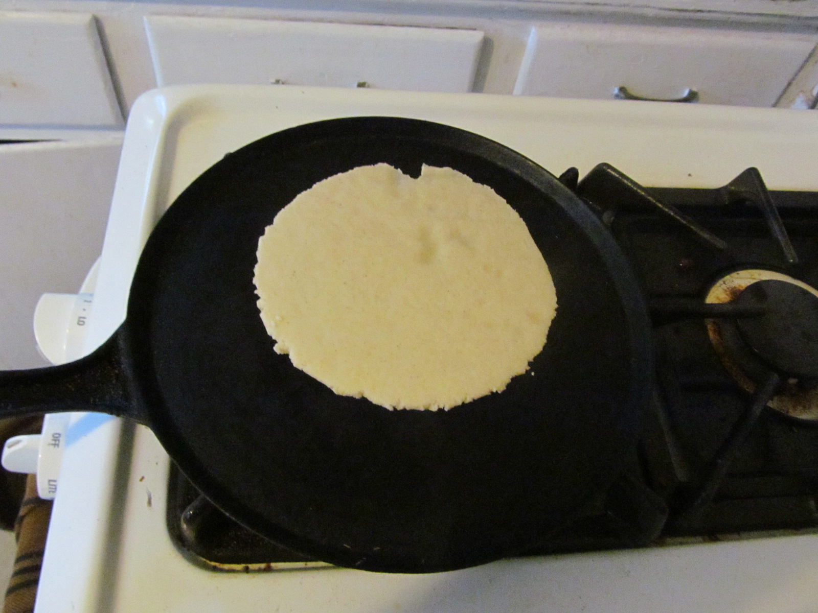 Tortilla grilling on a comal